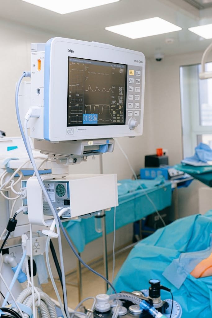 Close-up of vital signs monitor in a modern operating room setup.